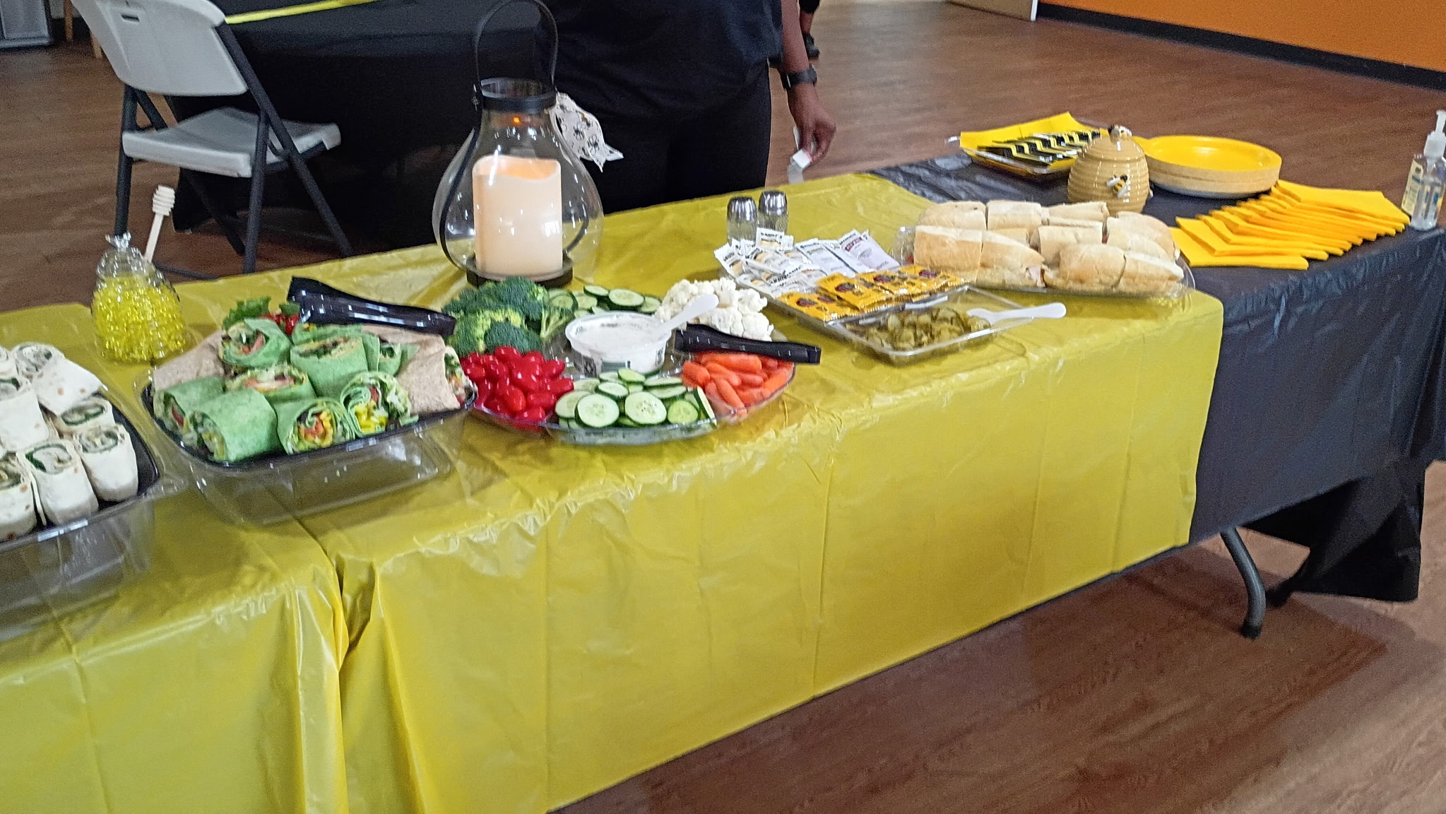 Refreshments arranged on a yellow and black event table