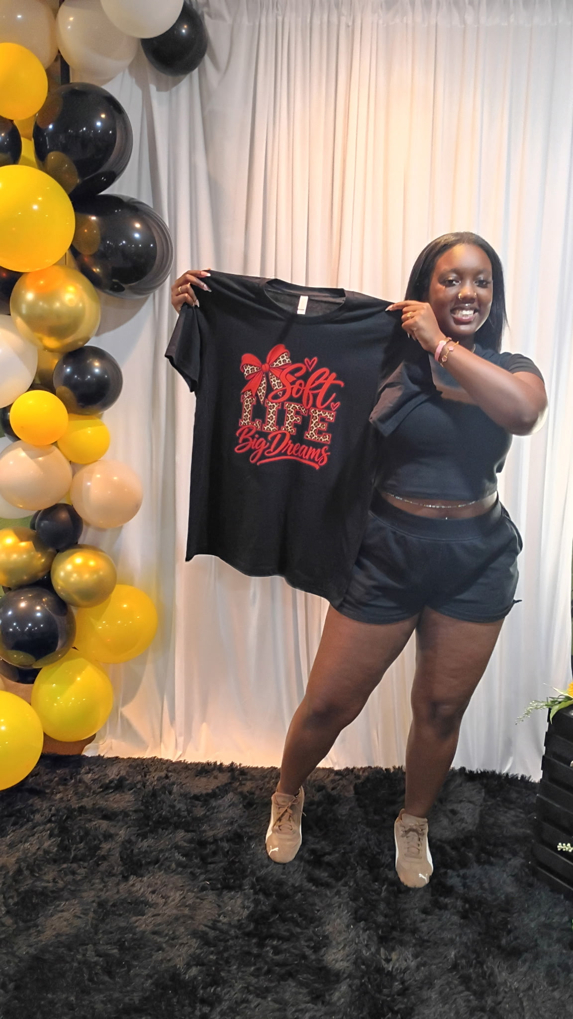Guest posing with her completed custom event shirt