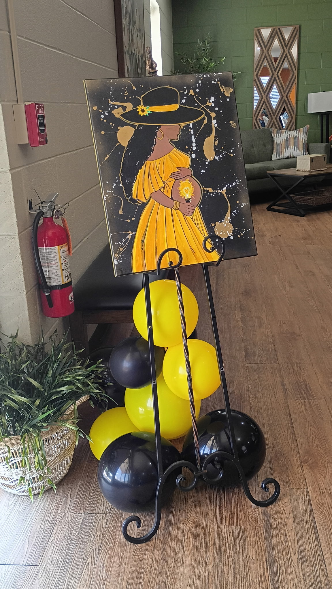 Black and yellow Bee's Tees event decor with balloons and custom artwork